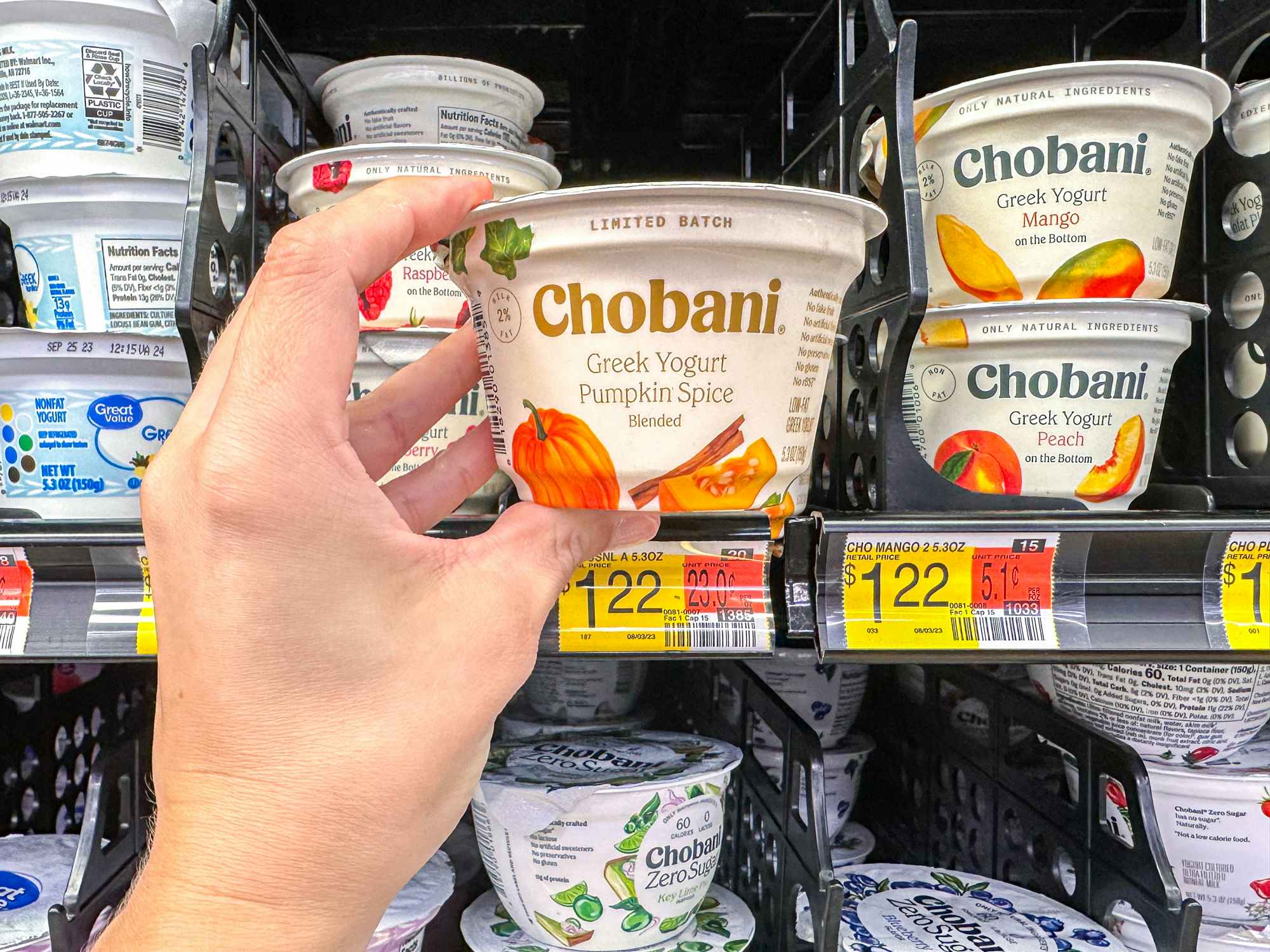 a person holding up a pumpkin chobani yogurt