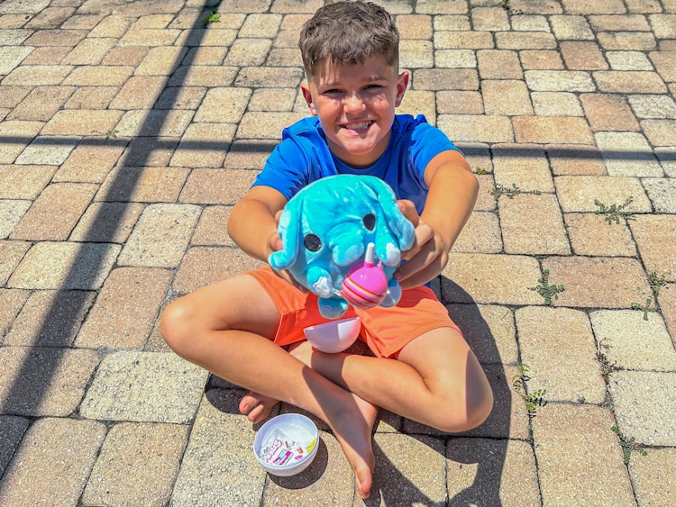 a child holding out a zuru snackles