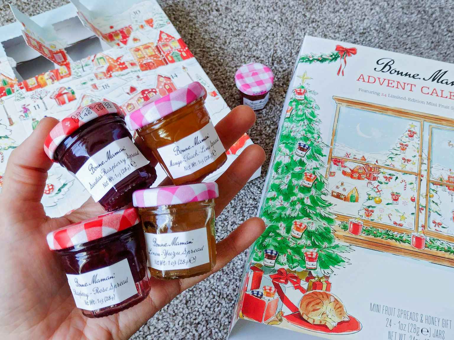 person holding jams and jellies from bonne maman advent calendar