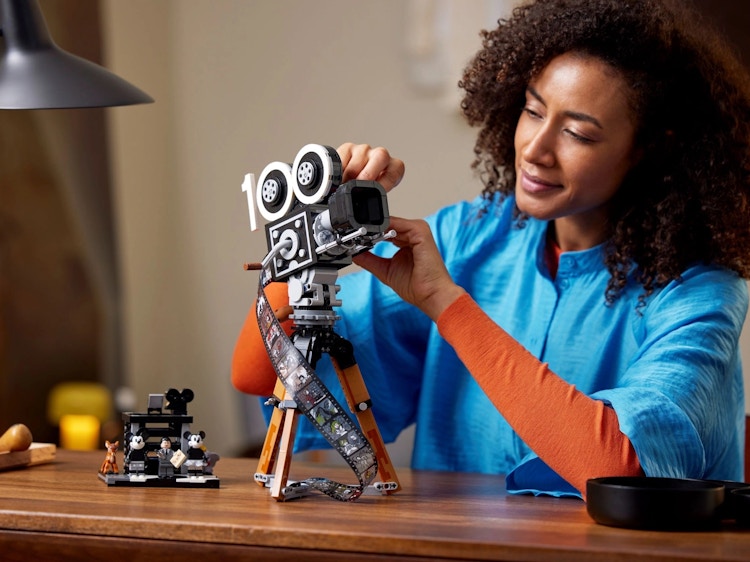 a person looking at a Lego Disney tribute camera