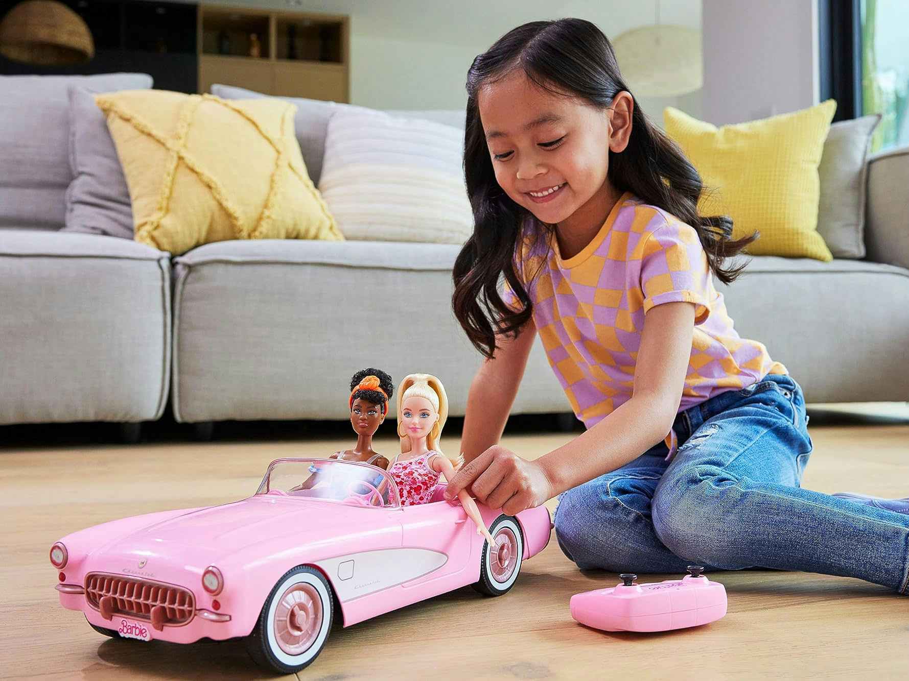 a child playing with a Barbie corvette