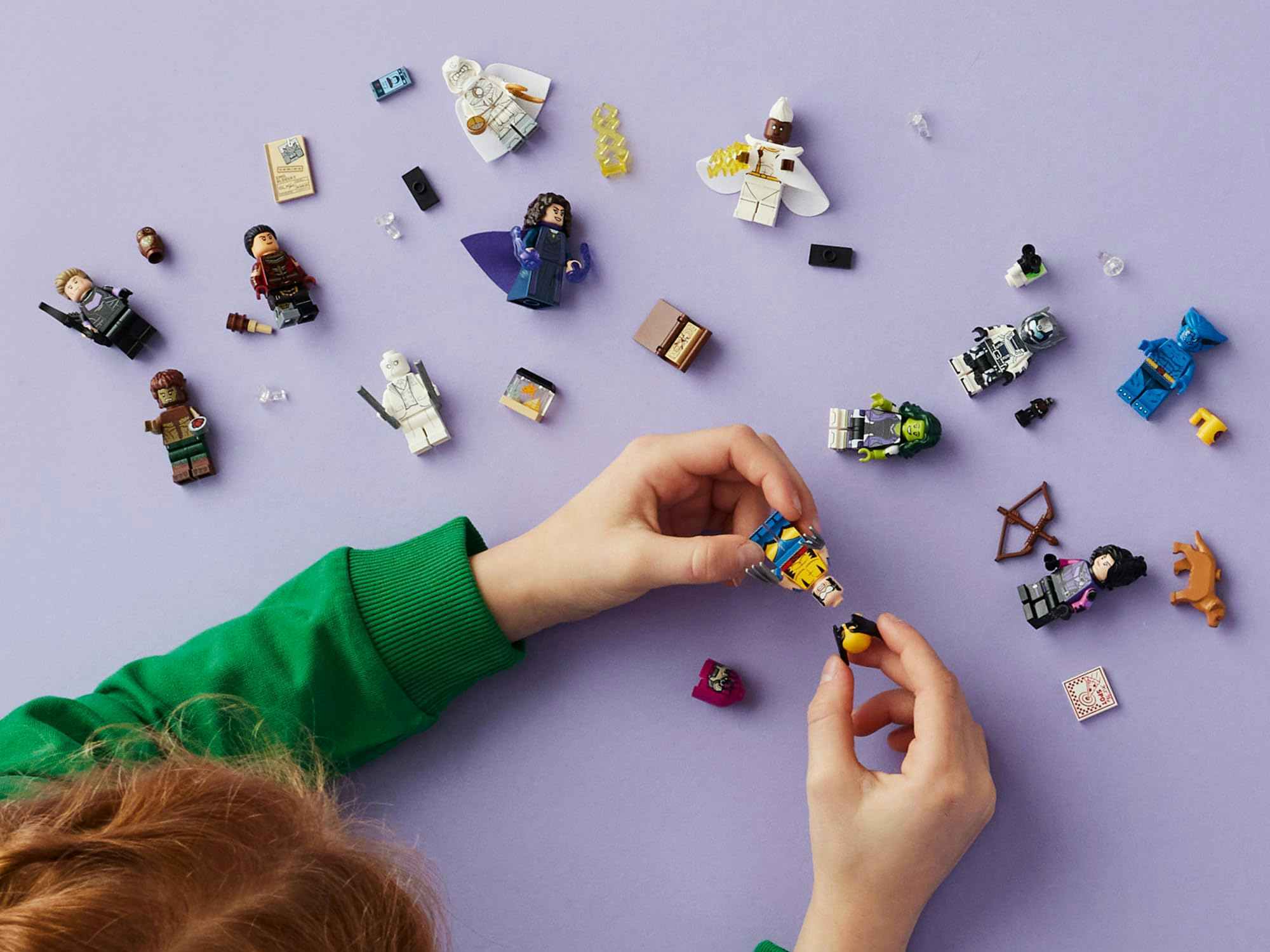 a child playing with Lego minifigures 