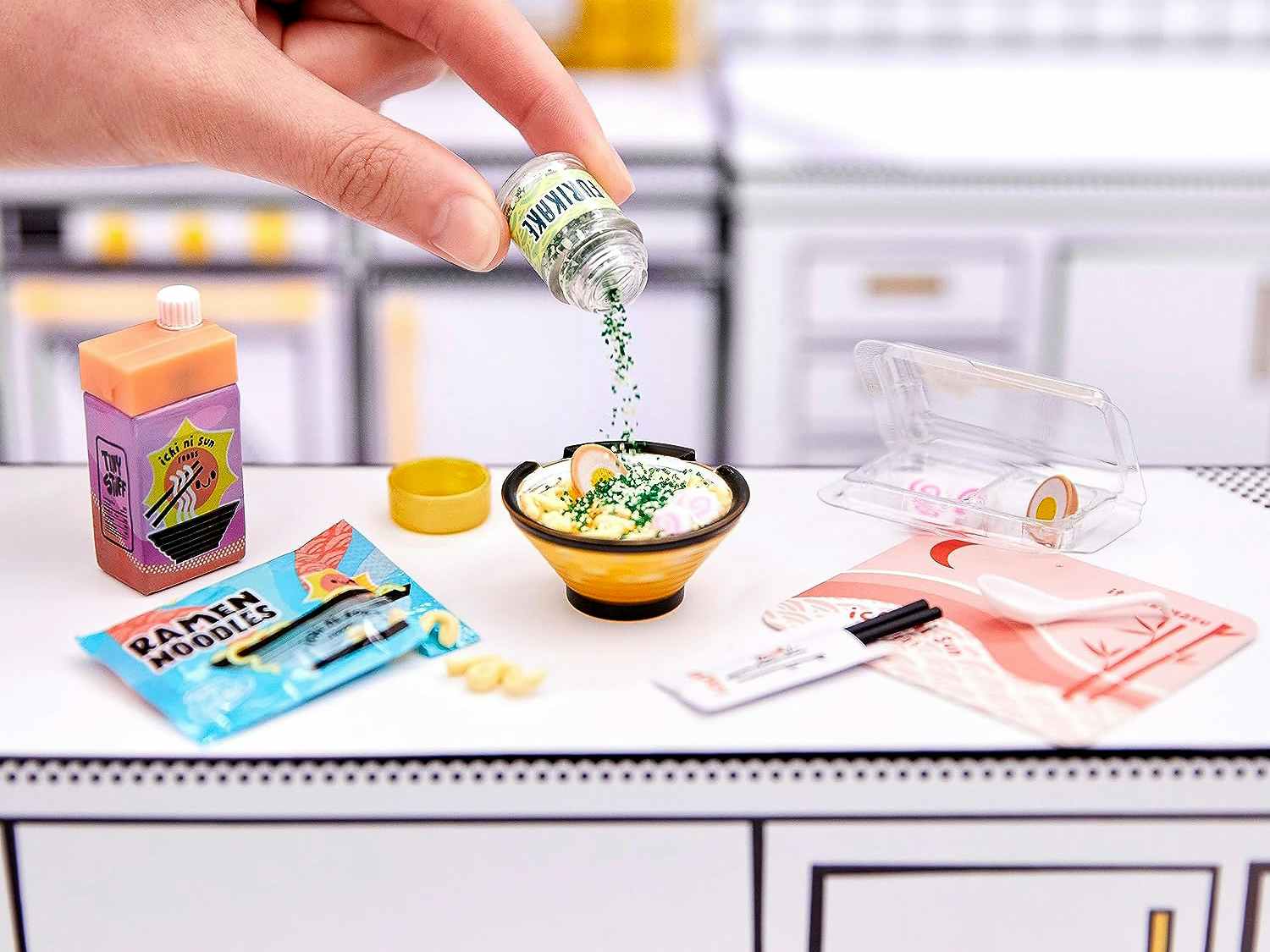 someone playing with a mini replica food set