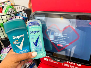 person holding two Degree deodorants next to price scanner