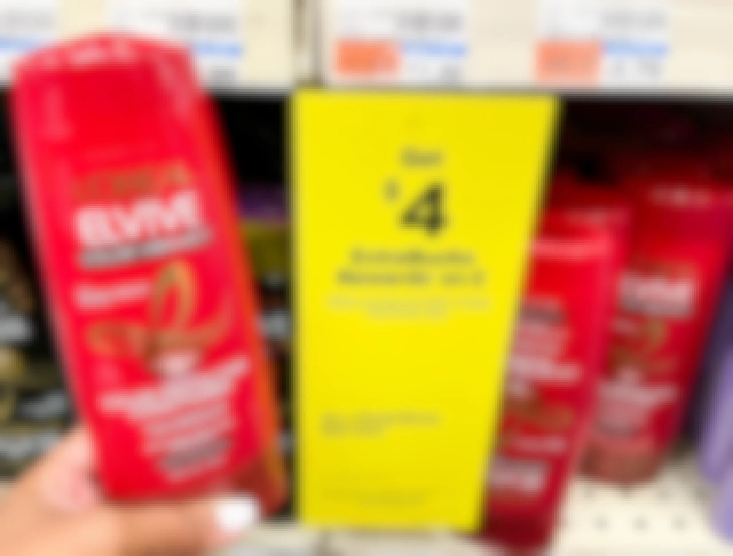person holding a bottle of L'Oreal Elvive next to sales tag