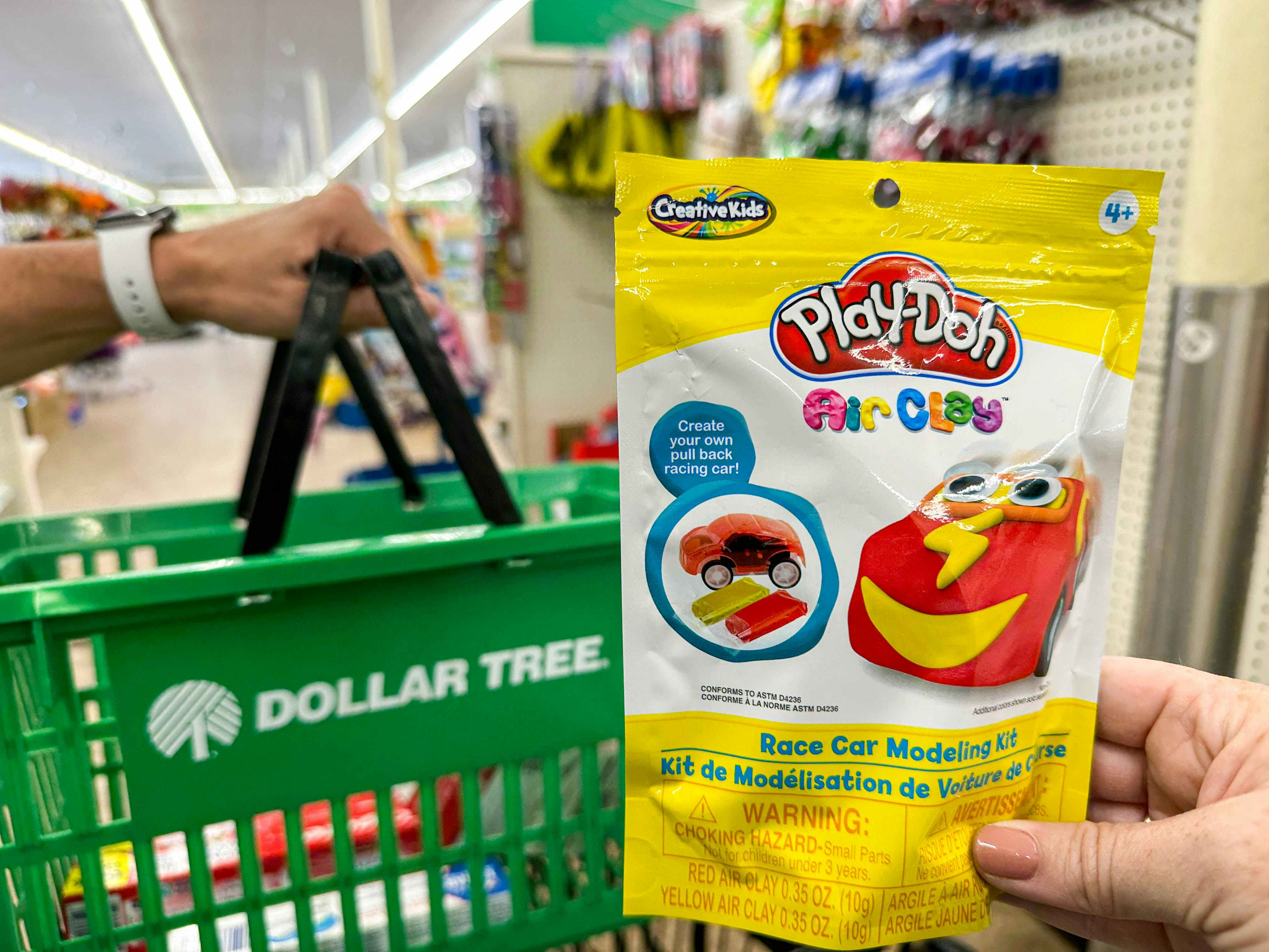 a person holding playdoh in dollar tree