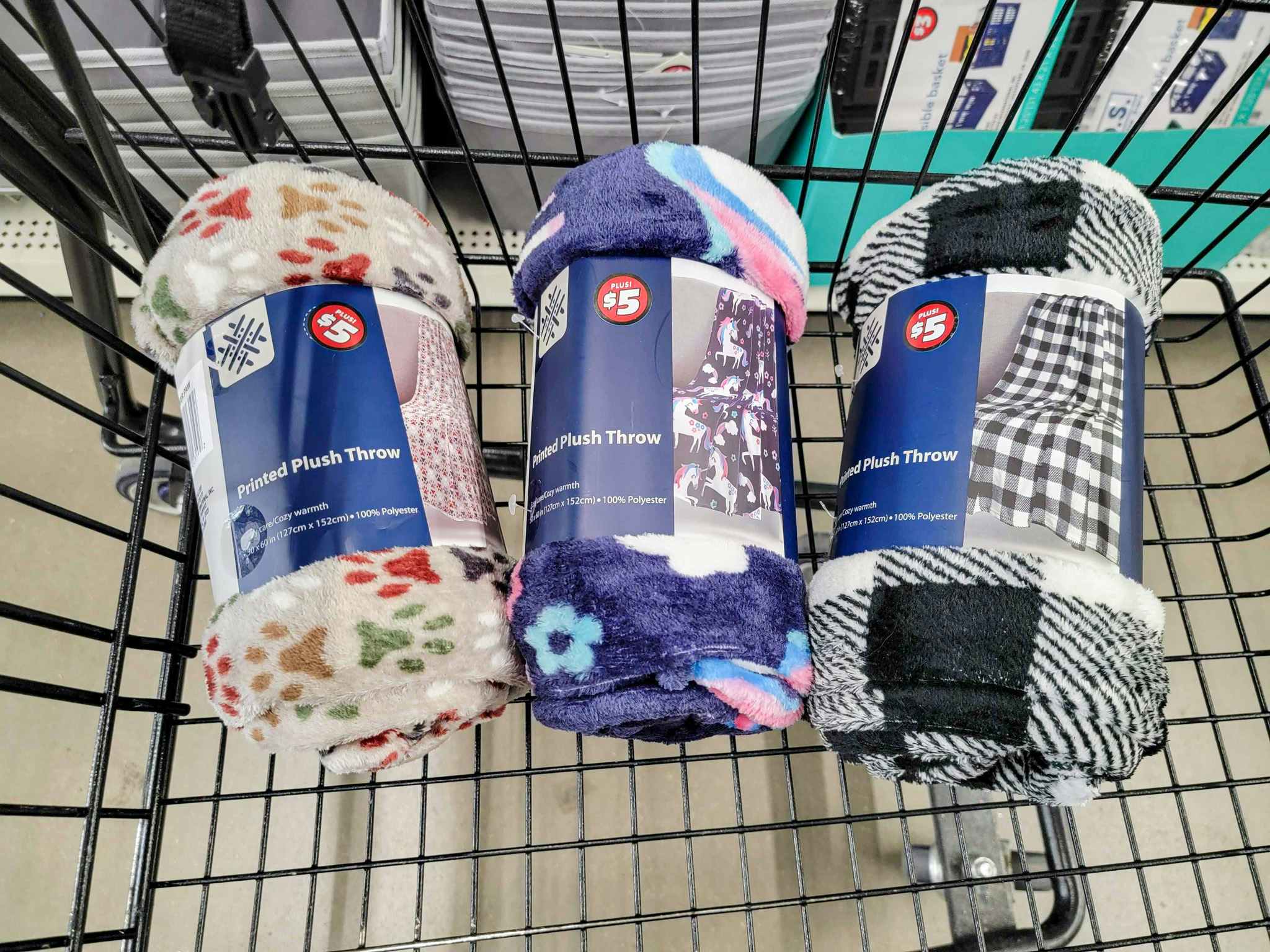 printed fleece blankets in a cart