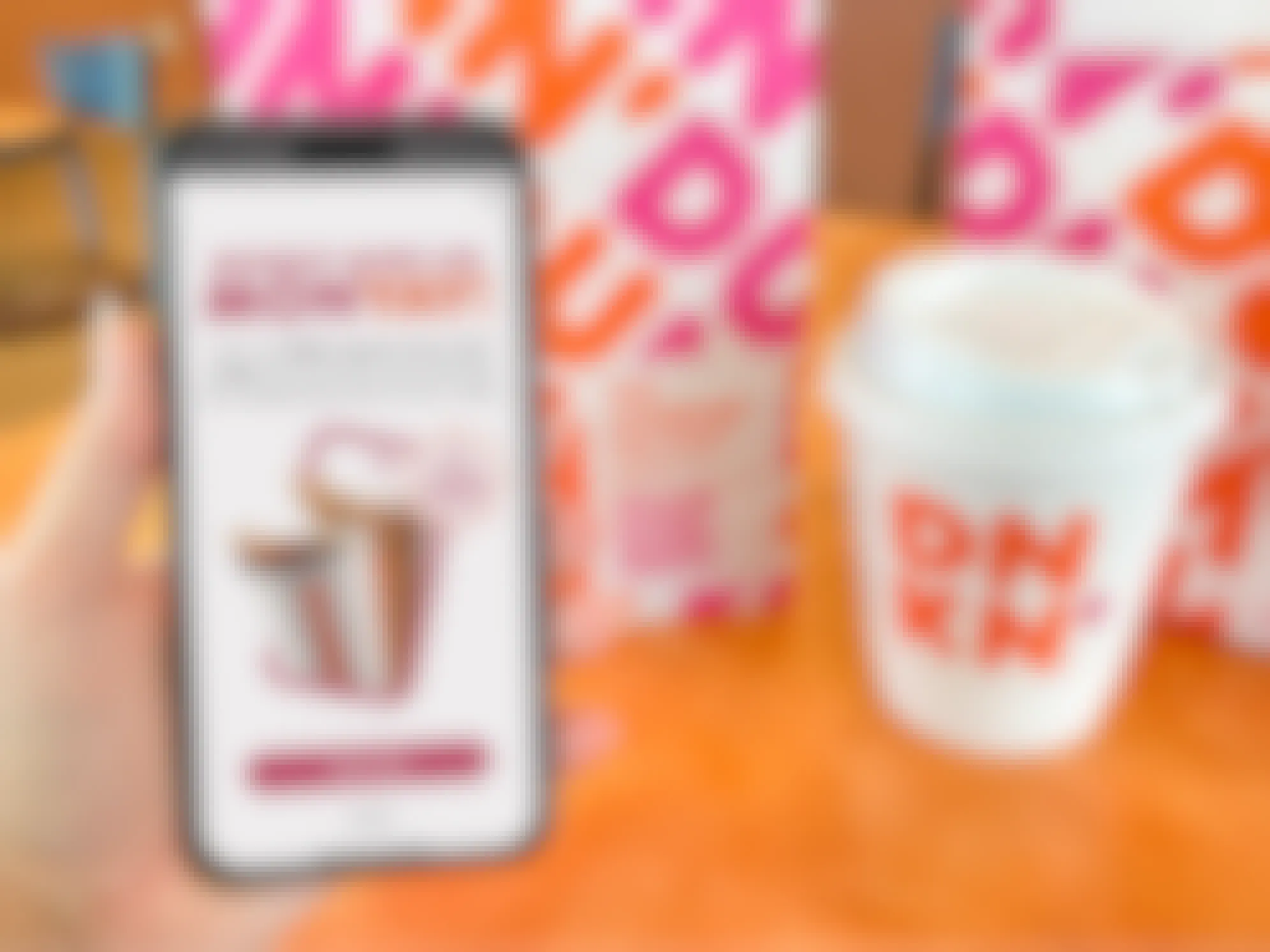 someone holding a phone displaying the pop-up for the Dunkin September Member Exclusive offer for free coffee on Mondays