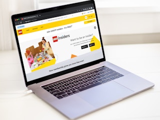 a laptop displaying the Lego Insiders webpage on the Lego website