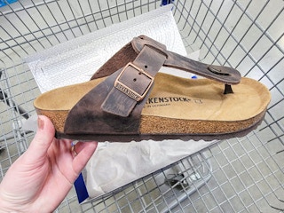 hand holding a birkenstock sandal