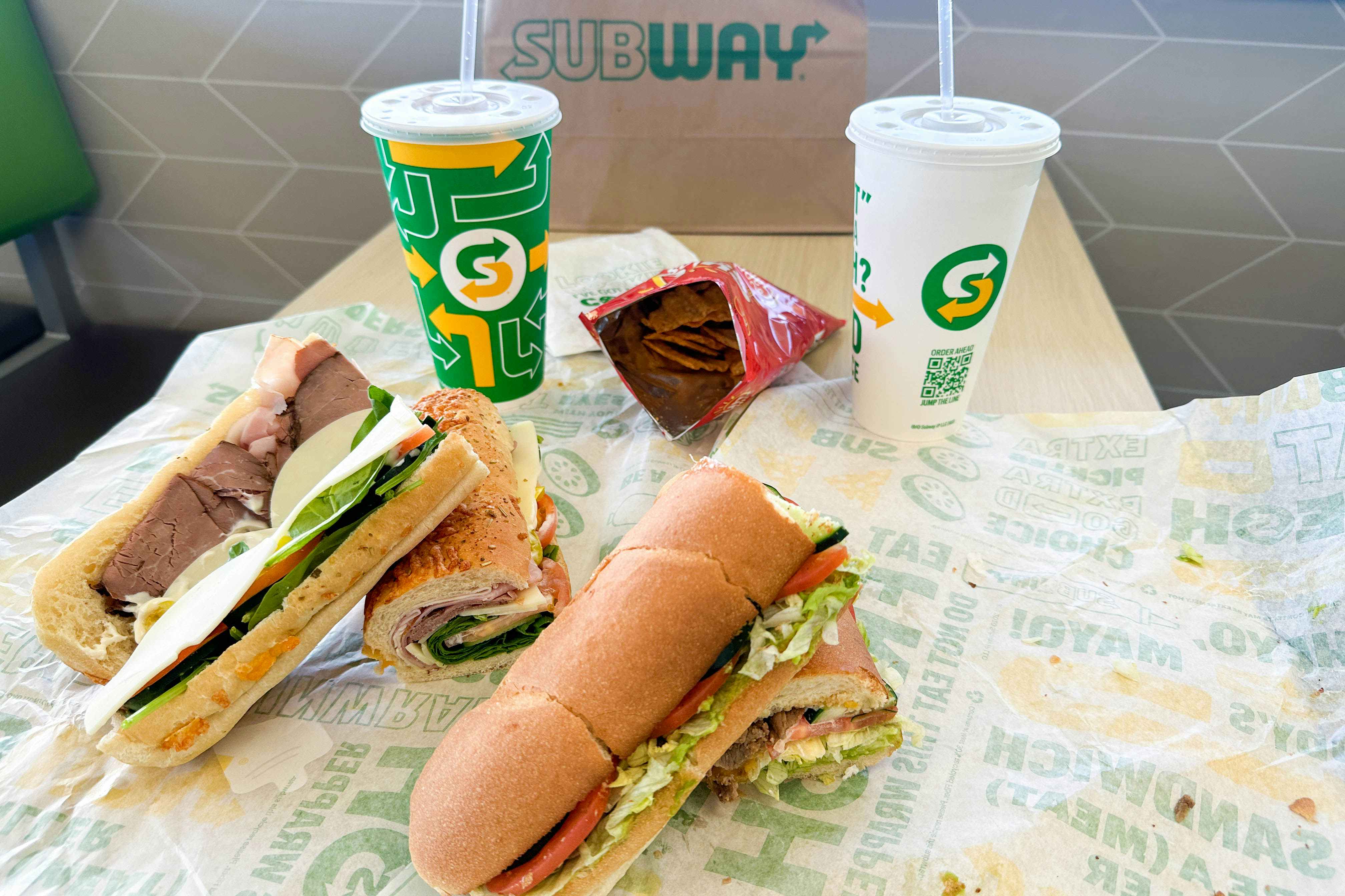 2 footlongs on a table in subway