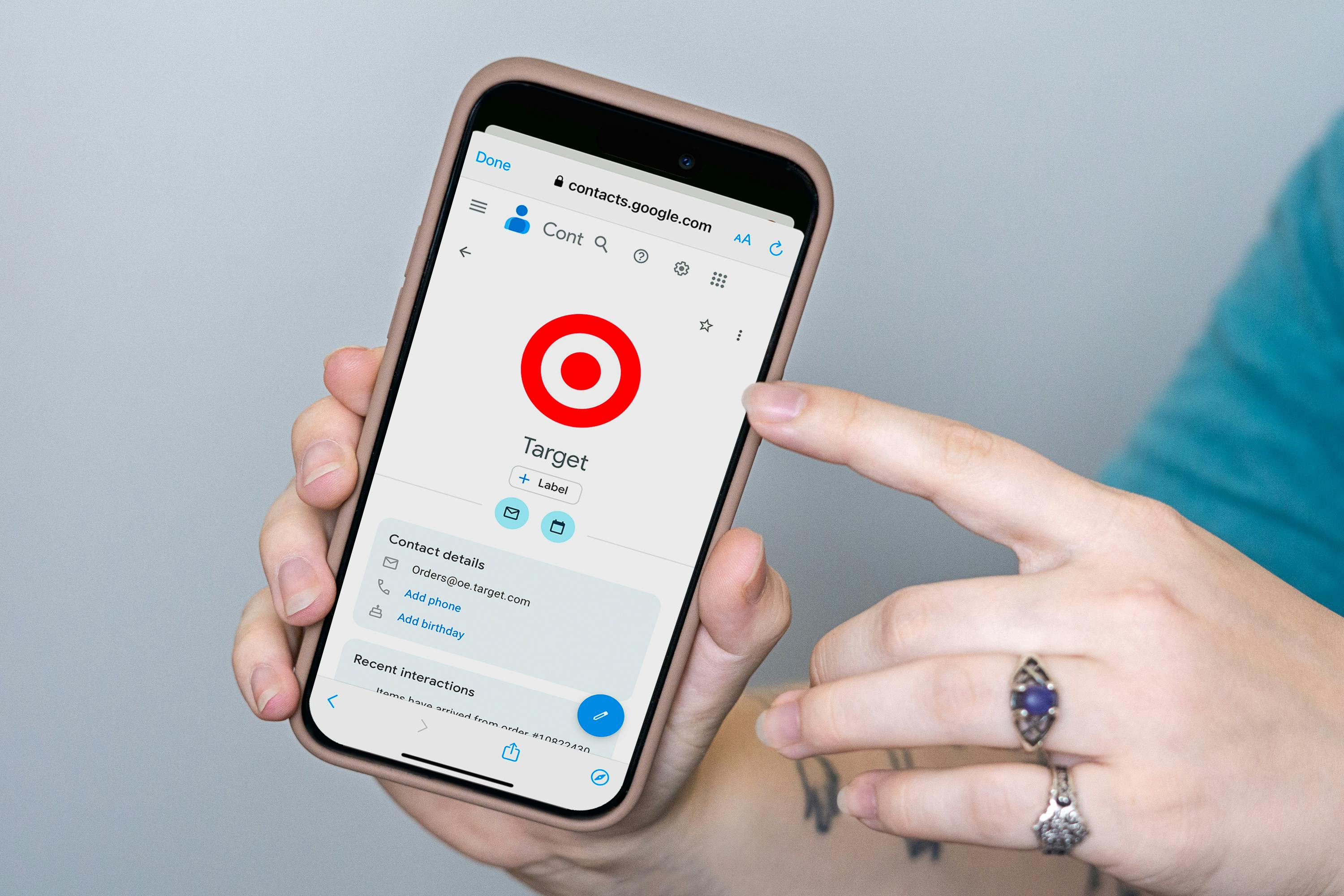 someone holding up a phone showing the Target email contact