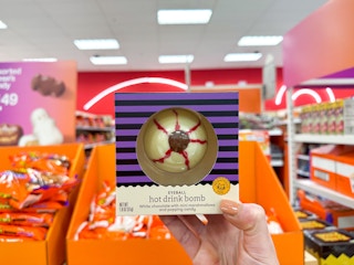 a person's hand holding up a halloween eyeball hot drink bomb at Target