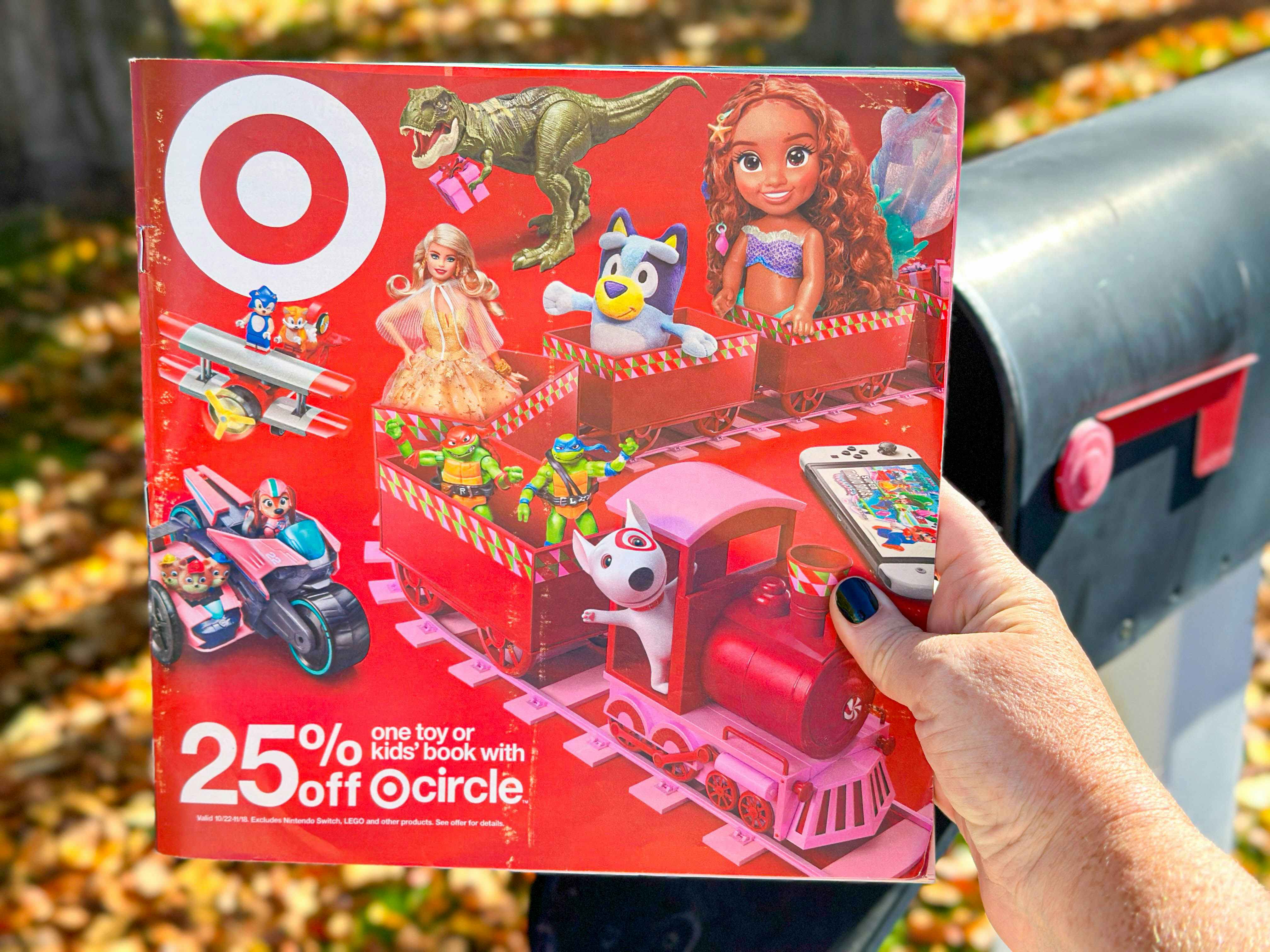 a target toy book being held in front of a mail box