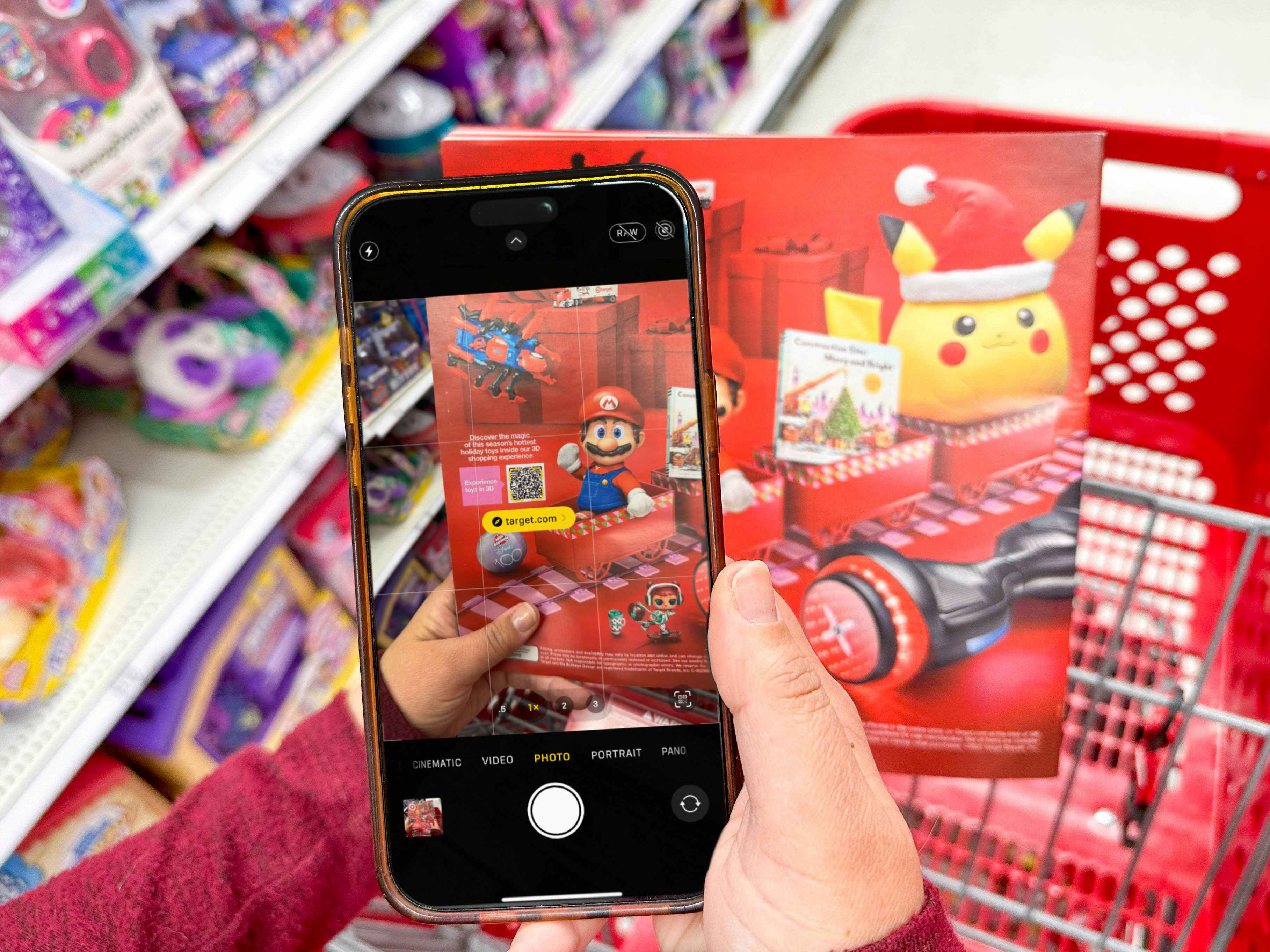 a person scanning a target toy book qr code with iphone in store