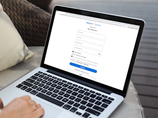 a person signing up for the walmart business program on their macbook