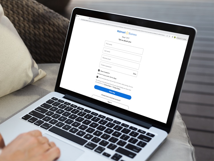 a person signing up for the walmart business program on their macbook 