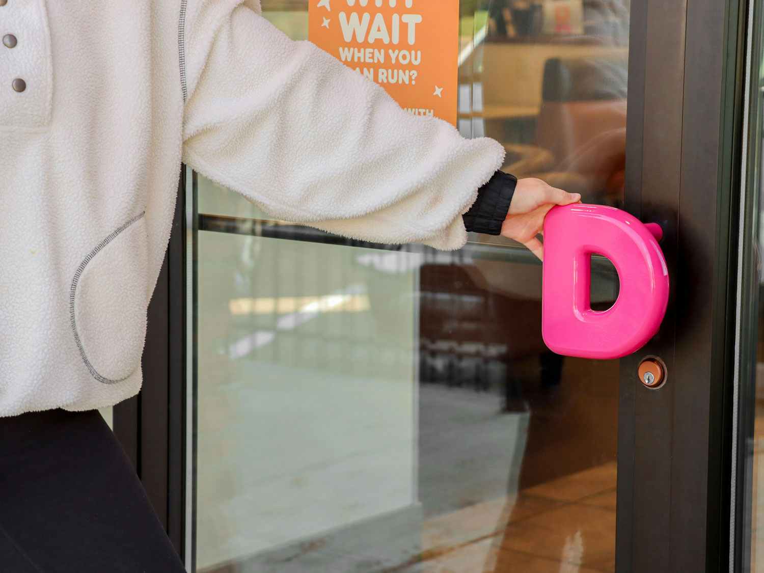 a person entering a dunkin donuts
