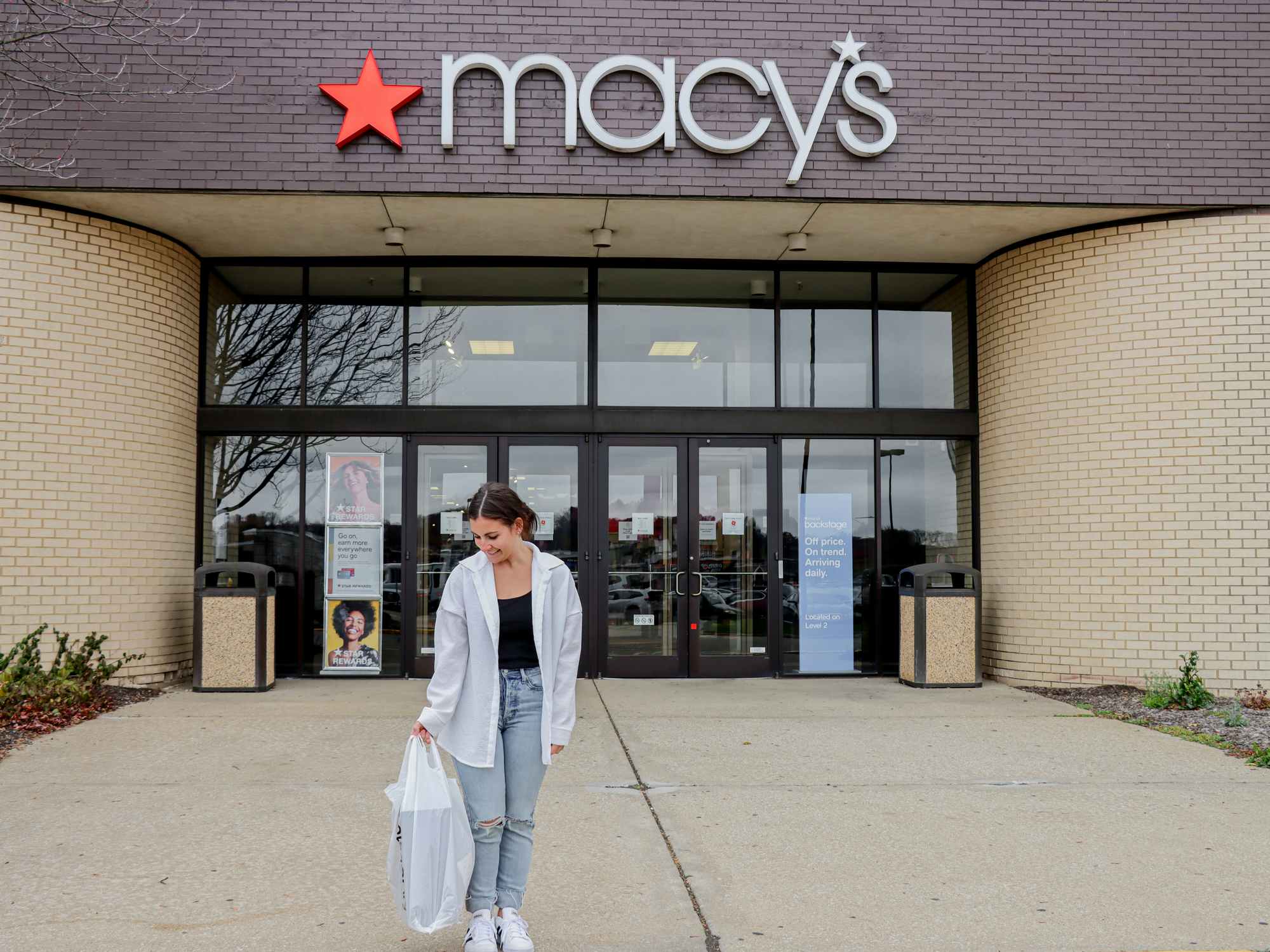 a woman walking out of macy