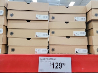 ugg boot boxes by a sign for $129.98