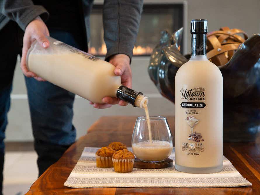 person pouring an uptown cocktails chocolatini pre-mixed drink at home