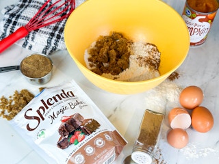 a package of splenda on a counter next to baking items in a bowl