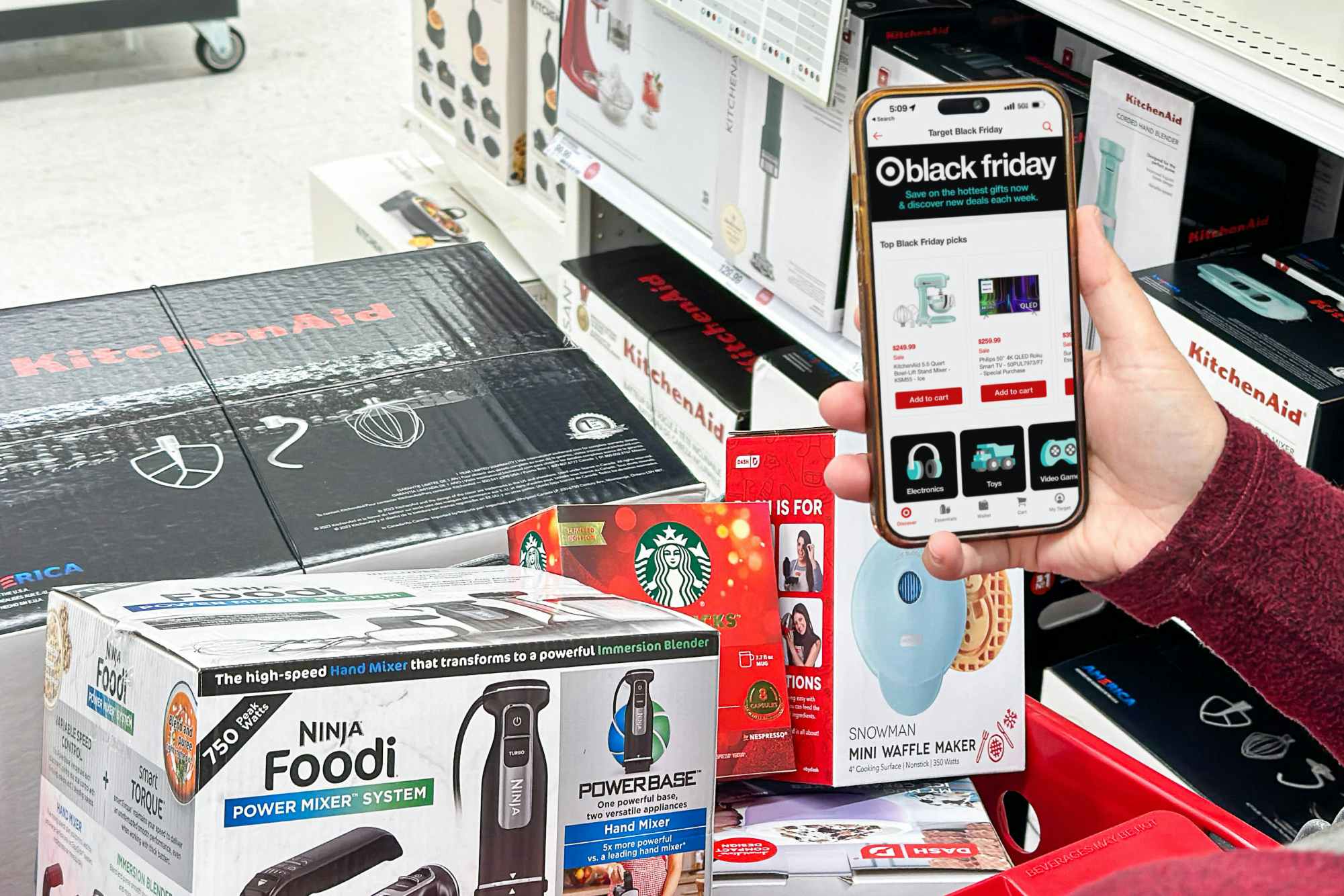 target app on phone being held in front of cart full of items